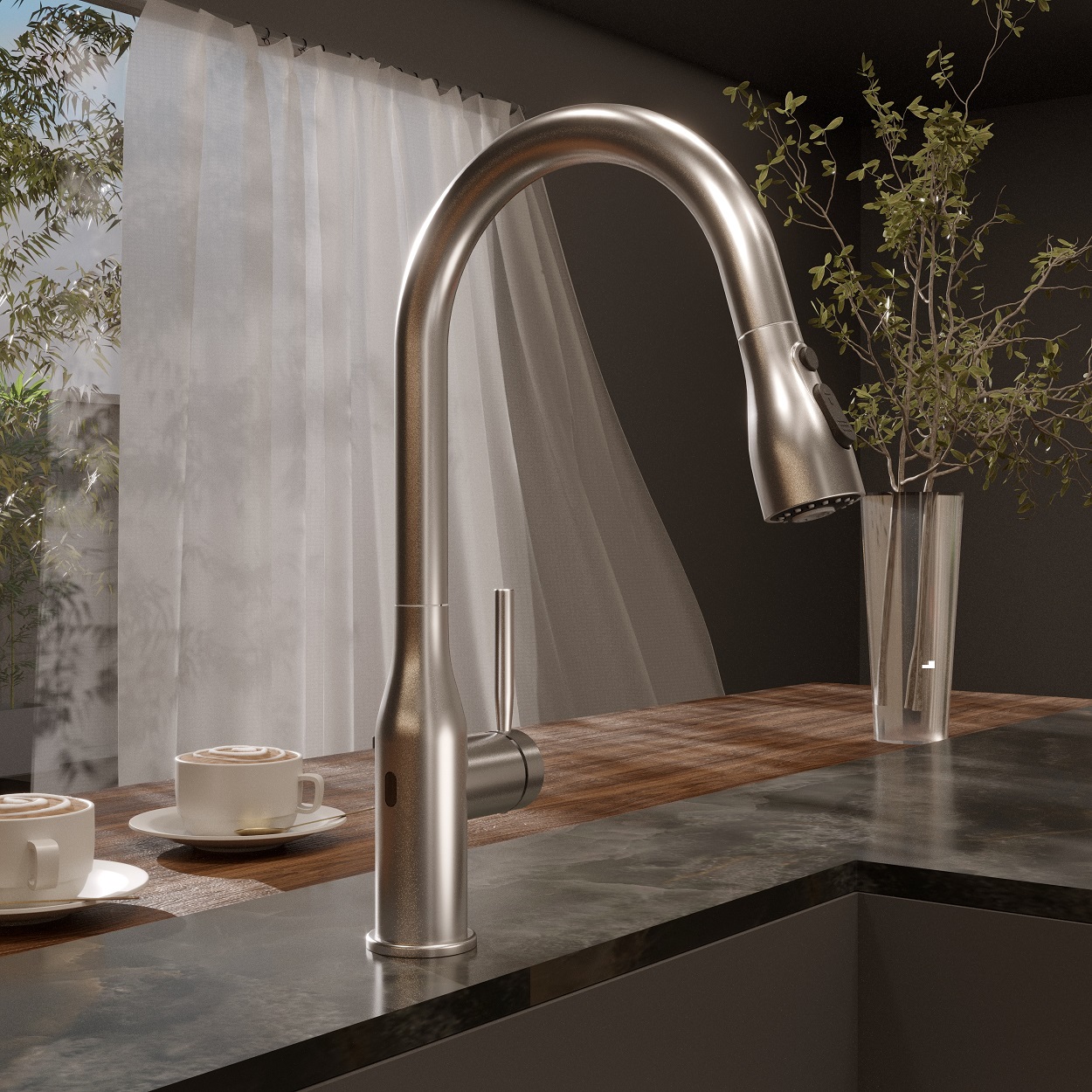 Llave de lavabo para cocina con acabado cromo, en un lavabo gris con plantas en el fondo.